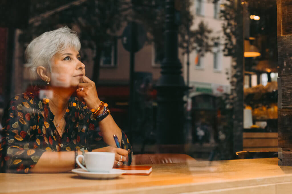 women daydreaming inside a coffee shop